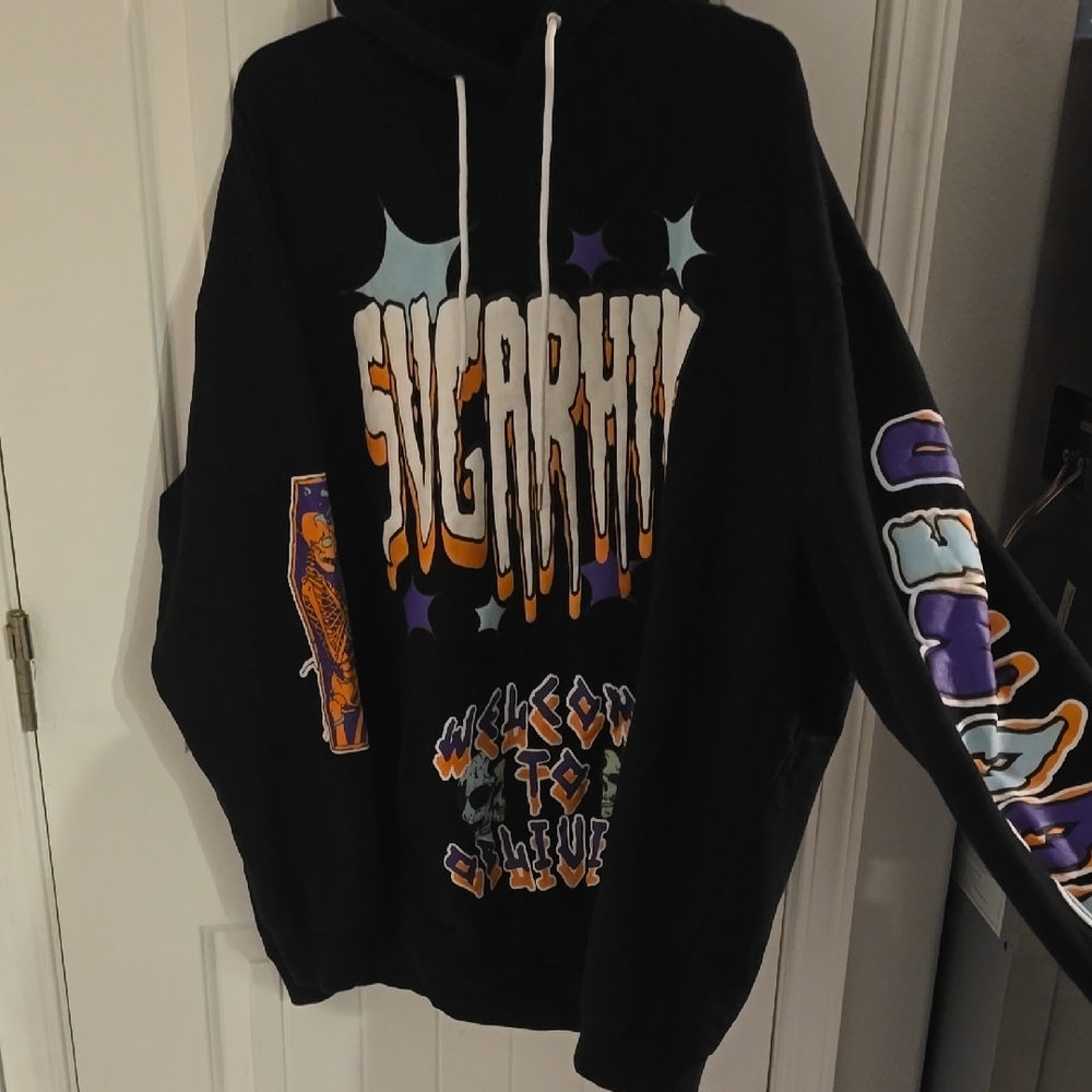 Black Sweater with Bold Graphic Design and Colorful Sleeve Art